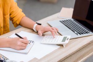 cropped shot of woman working with calculator