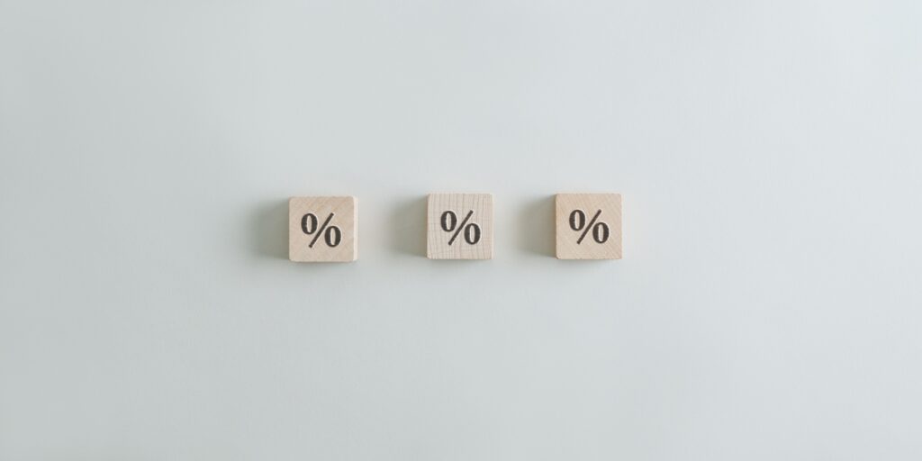 Three wooden cubes with percentage symbol on them